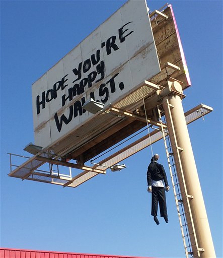 billboard sign with mannequin on noose