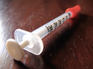 insulin syringe lying on table surface