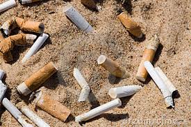 Cigarette butts in sand Cigarette butts in sand