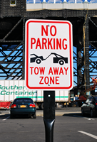 No Parking Tow Zone with Tow Truck Symbol Sign